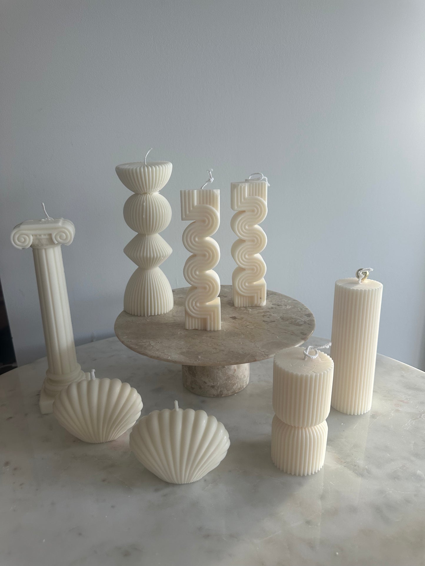 Modern geometric pillar candles for weddings, baby showers, and party décor, available for wholesale in USA & Canada